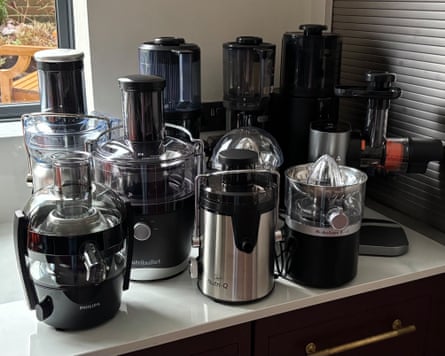 Lineup of all the juicers featured in this group test on a kitchen work surface.