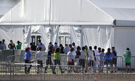 Children line up to enter a tent at the Homestead shelter for unaccompanied children in Homestead, Florida in February 2019.