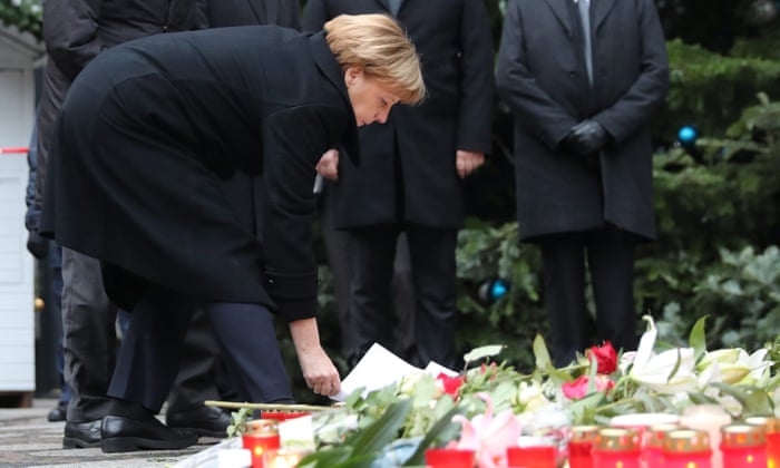 Chancellor Angela Merkel lays flowers at the attack scene.