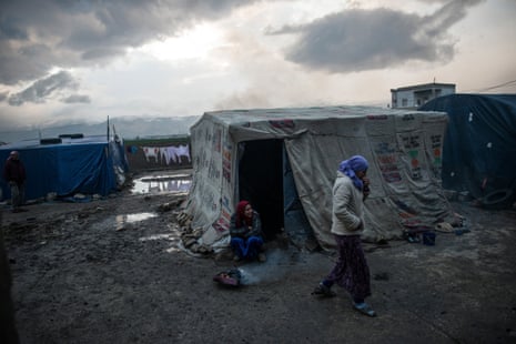 Syrian refugees live in the shell of a bombed-out factory in the Bekaa valley, Lebanon