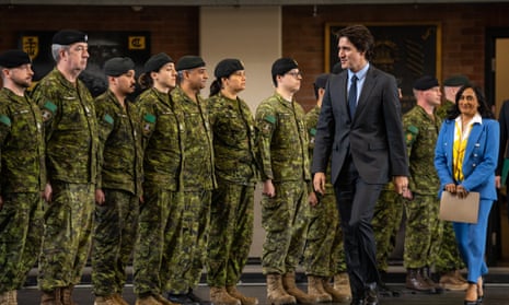 Canadian Prime Minister Justin Trudeau and Defence Minister Anita Anand walk in front of a line of Canadian troops on the one-year anniversary of Russia's invasion of Ukraine at Fort York Armoury on February 24, 2023 in Toronto, Canada.