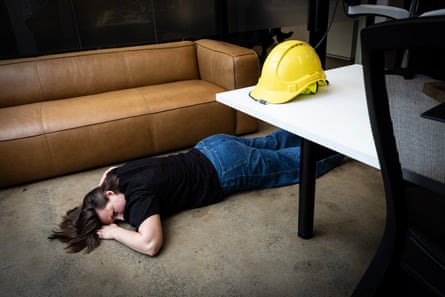 Emma lays down on the floor of the office