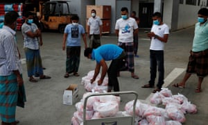 Coronavirus live news: US bars travel from Brazil as British PM’s adviser reported to police over lockdown breach 1 Migrant workers living in a factory-converted dormitory collect meals donated by charities for their Eid-al-Fitr celebrations.