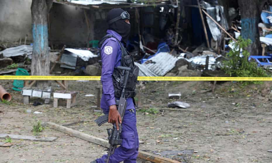 A Somali policeman at the scene of a previous suicide bombing in Mogadishu in November