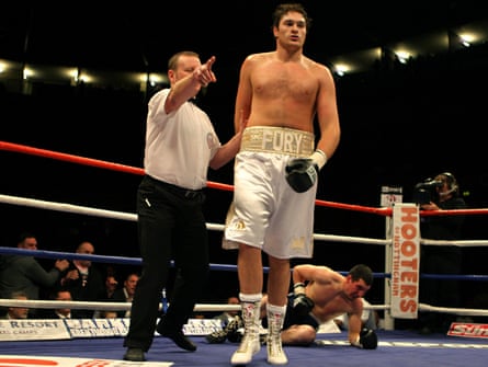 Tyson Fury is ushered away after knocking out Bela Gyongyosi in the first round of his professional debut.