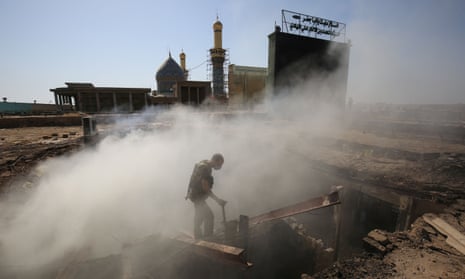 TOPSHOT - An Iraqi policeman inspects the aftermath scene of a mortar and bombing attack on the Sayyid Mohammed shrine in the Balad area, located 70 kilometres (around 45 miles) north of Baghdad, on July 8, 2016. Islamic State group militants killed 30 people at the Shiite shrine, striking the area with suicide bombers, gunfire and mortar rounds, an Iraqi security spokesman said. The attack came just five days after a suicide bomber detonated an explosives-rigged minibus in the capital, killing 292 people. / AFP PHOTO / Ahmad al-RubayeAHMAD AL-RUBAYE/AFP/Getty Images