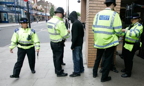 Police perform a stop and search in Harrow, London.