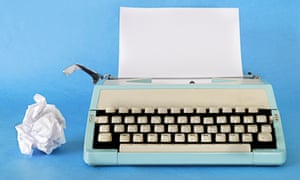 Retro TypewriterManual Typewriter Circa 1970 with a blank sheet of paper and rejected work alongside