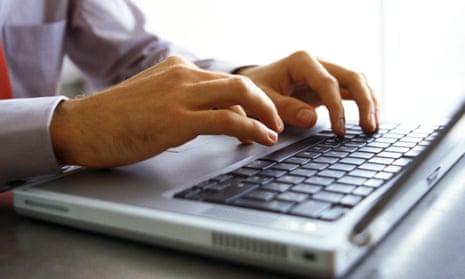 Stock image of a man's hands on laptop keyboard