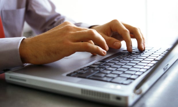 Man’s hands on keyboard of laptop