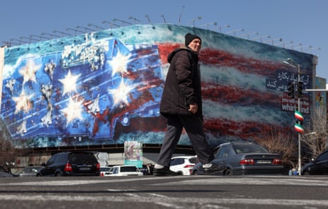 A man walks near an anti-US billboard in Tehran.