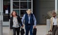 Man in cowboy hat with woman carry bags outside court