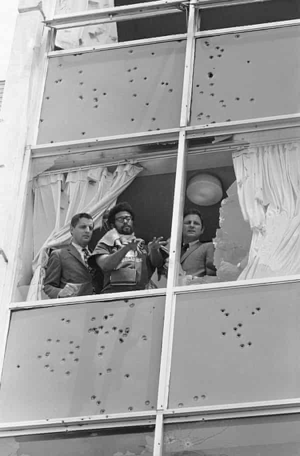 On 20 May 1970, Democratic senators Walter Mondale and Birch Bayh look from the shattered windows of Alexander Hall.