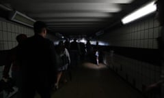 People walking in complete darkness at Clapham Junction station in London during last week’s power cuts.