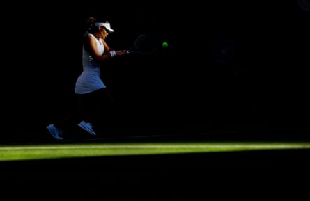 Emma Raducanu plays a backhand in her victory over Mimi Xu on day one at Wimbledon.