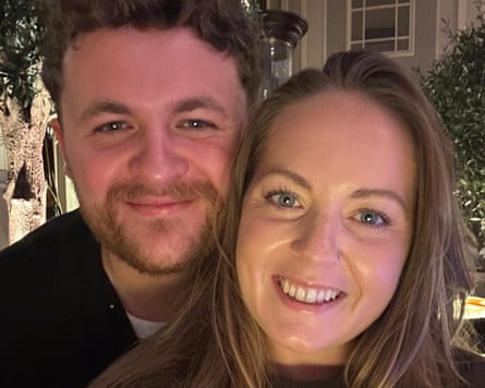 Young man and young woman cheek to cheek posing for photo looking happy