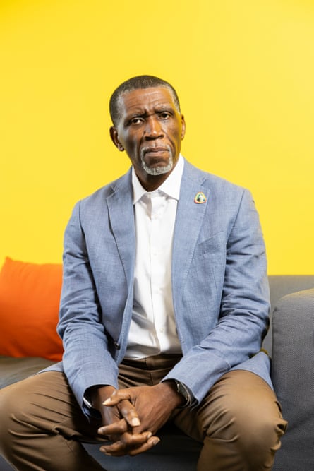Man sits in front of yellow background.