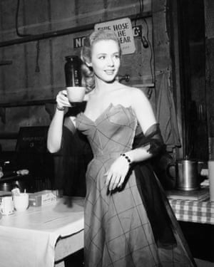 Piper Laurie having a cup of coffee on the set of the noir thriller, Dangerous Mission, 1954