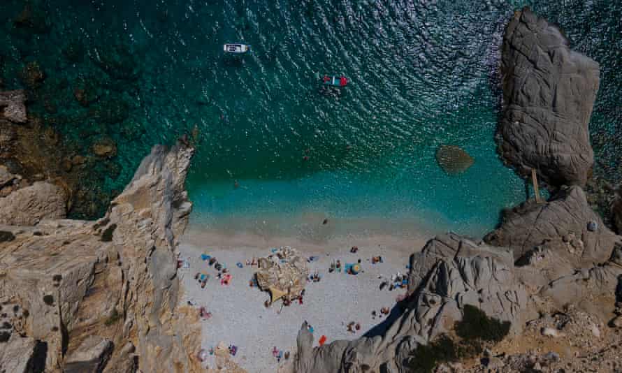 Swimmers and sunbathers at ‘Seychelles’ in the island of Ikaria, Greece