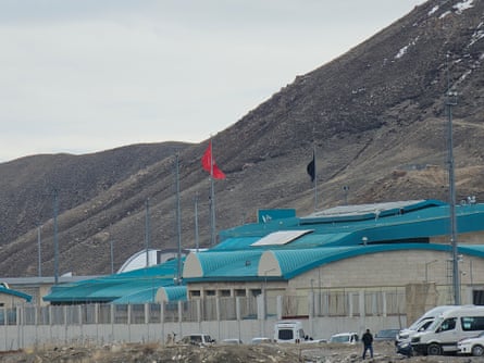 A large grey building with turquoise roof
