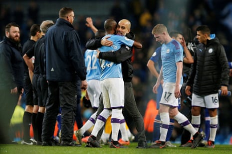 Manchester City manager Pep Guardiola celebrates with Fernandinho after the final whistle.