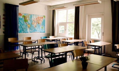 Desks and chairs arranged in classroom