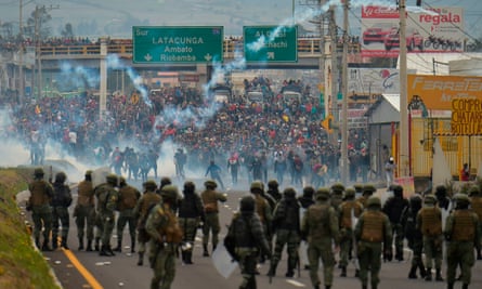 Demonstrators and riot police clash in Quito.