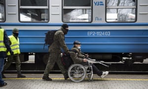 Russia-Ukraine war latest: Moscow says warship still afloat despite explosion; west says Ukraine claim of strike ‘credible’ – live | World news 2 A soldier assisting a refugee from Ukraine in Przemysl, Poland.