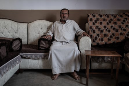 A man sits on a sofa
