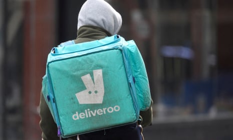 A Deliveroo delivery rider cycles in London.