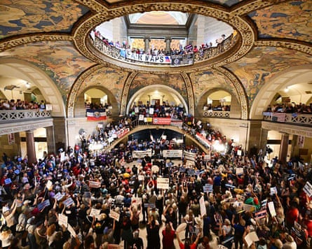 People gathered at the Missouri statehouse under dome and decorated ceiling