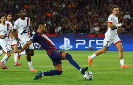 Barcelona's Ferran Torres slides the ball home to open the scoring against PSG.