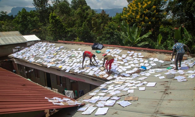 Students dry books and papers on the roof of their school in Mbale, Uganda