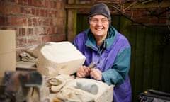 Sculptor Ane Freed-Kernis posing with a block of stone she's set to carve