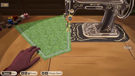 A hand holds some fabric as it’s passed under the needle of an ornate sewing machine.