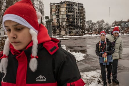 From left, Vlad, Maxim and Artem, from Borodianka, wear newly bought Santa Claus hats