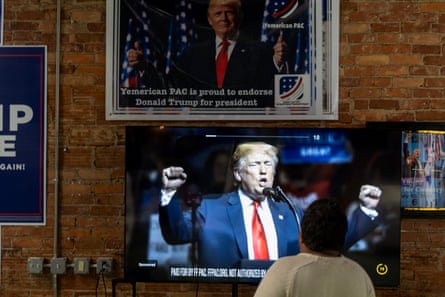a person watches a Trump TV ad