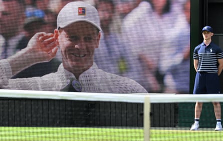 Italy’s Jannik Sinner image is seen on a large courtside screen