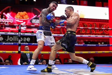 Teófimo López, right, lands a block on Arnold Barboza Jr during last year’s junior welterweight title fight in Times Square.