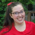 A young woman smiles.