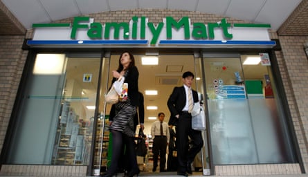 People walk out from a FamilyMart convenience store in Tokyo