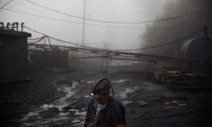 A coalminer walks through the morning fog before going underground in a mine less than 40in high in Welch, West Virginia.