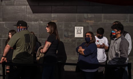 People wearing face masks and not stand in line in front of Hodads Restaurant in Ocean Beach in San Diego, California on February 13, 2021.