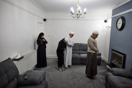 15 May: Irhfan Mururajani leads his family in prayer at their home in Leicester during Ramadan.