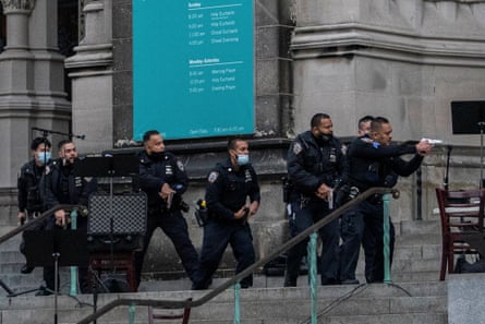Police officers move towards the gunman on the steps of the Cathedral Church of St John the Divine in Manhattan.
