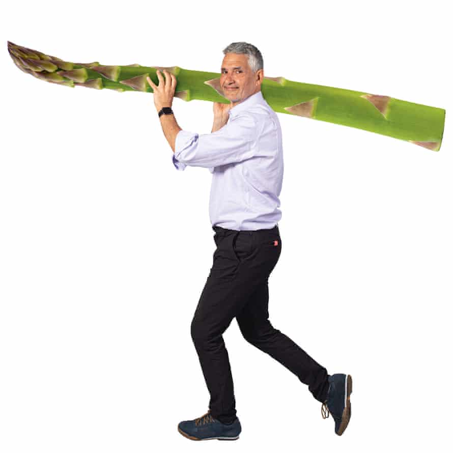Tim Specter carrying giant asparagus