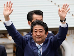 Shinzo Abe waves to voters