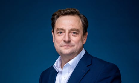 Portrait of Alex Cresswell against a blue background