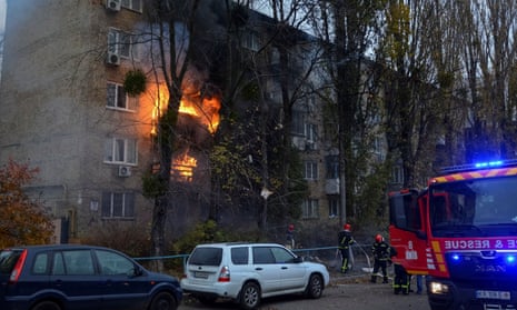 Firefighters work to put out a fire in a residential building hit by a Russian missile strike in Kyiv.