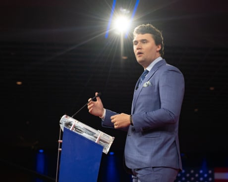a man in a suit speaks into a microphone